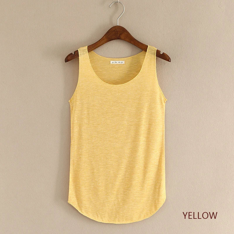 Yellow tank top on a wooden hanger against a beige background