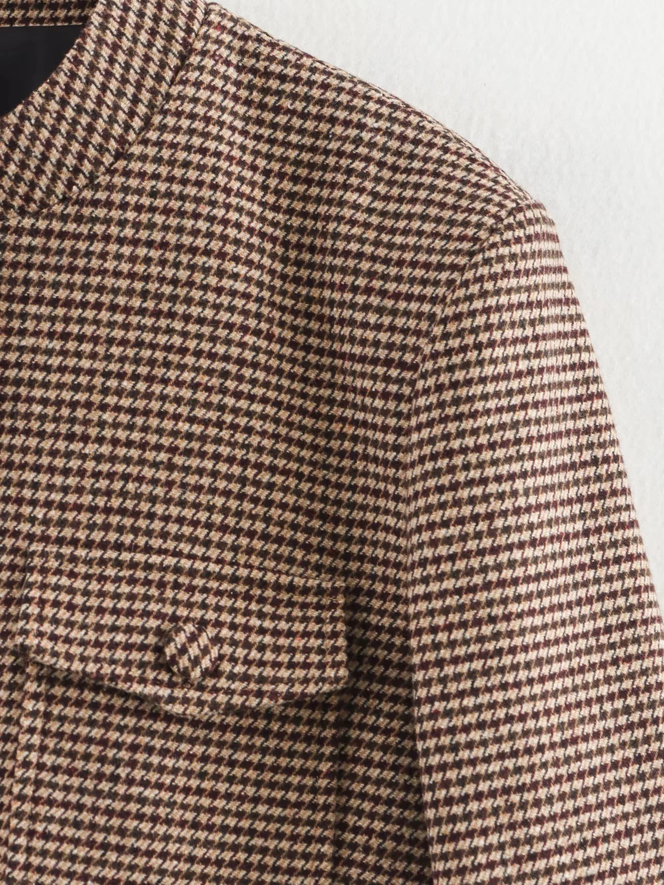 Close-up of a houndstooth patterned fabric with a pocket.