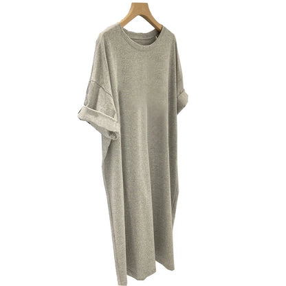 Gray dress on a wooden hanger against a white background