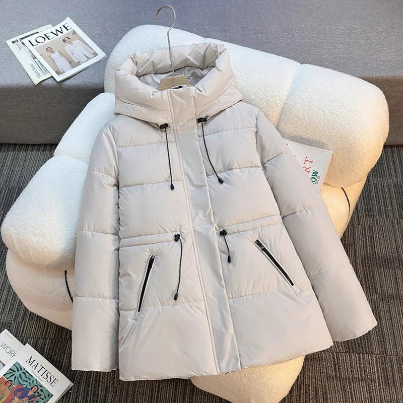 Beige puffer jacket on a mannequin with a soft surface background