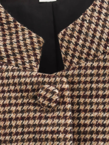 Close-up of a houndstooth patterned vest with a black bow tie.