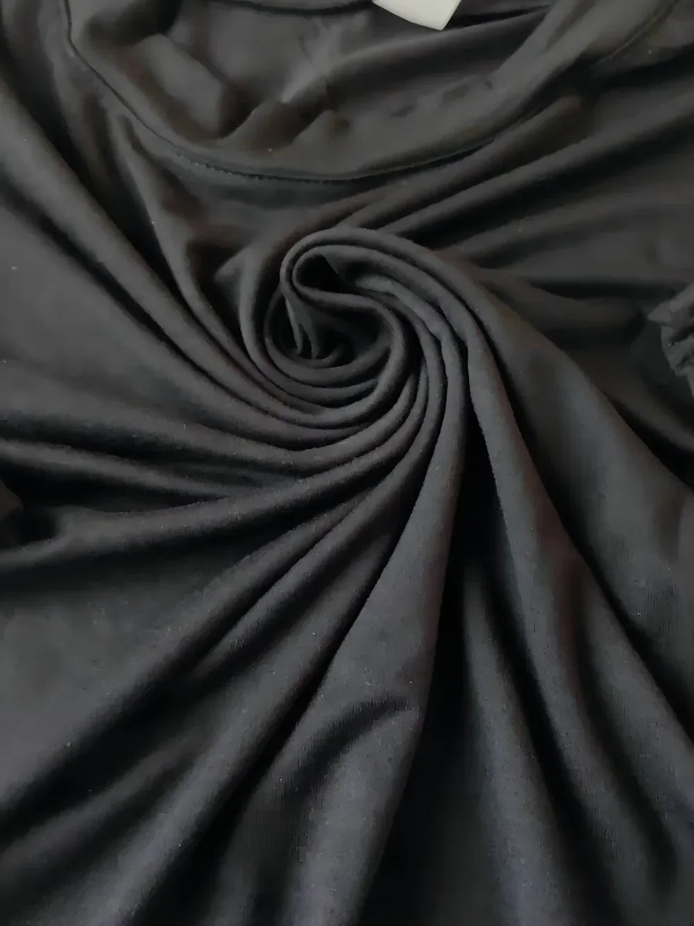 Close-up of dark gray fabric with folds