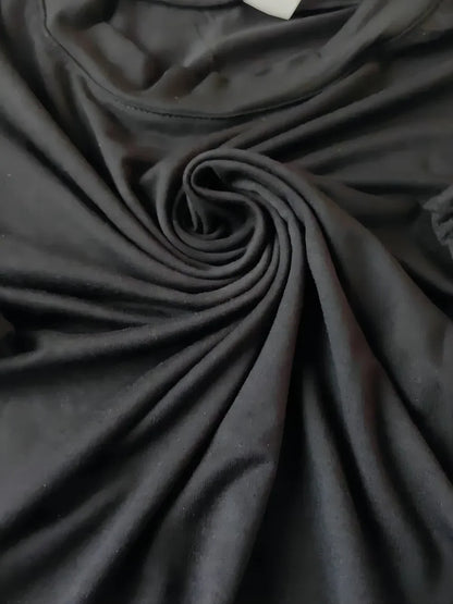 Close-up of dark gray fabric with folds