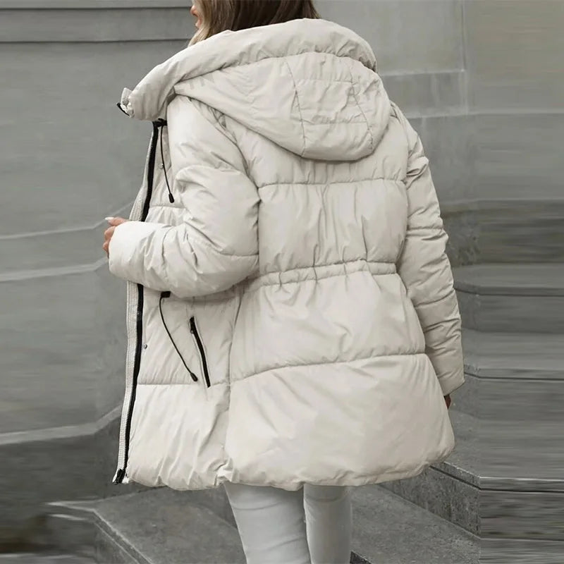 Person wearing a white puffer jacket in an urban setting