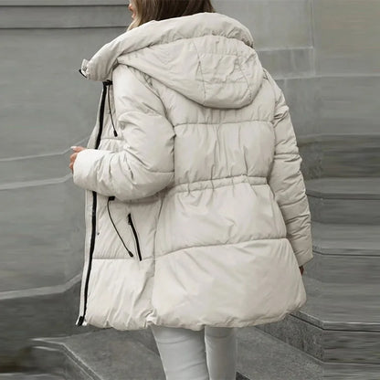 Person wearing a white puffer jacket in an urban setting