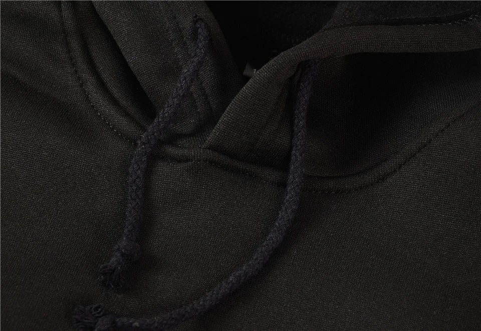 Close-up of a black hood with a drawstring on a dark background