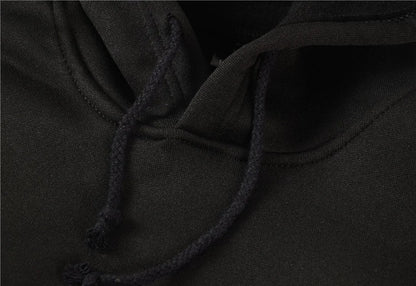 Close-up of a black hood with a drawstring on a dark background