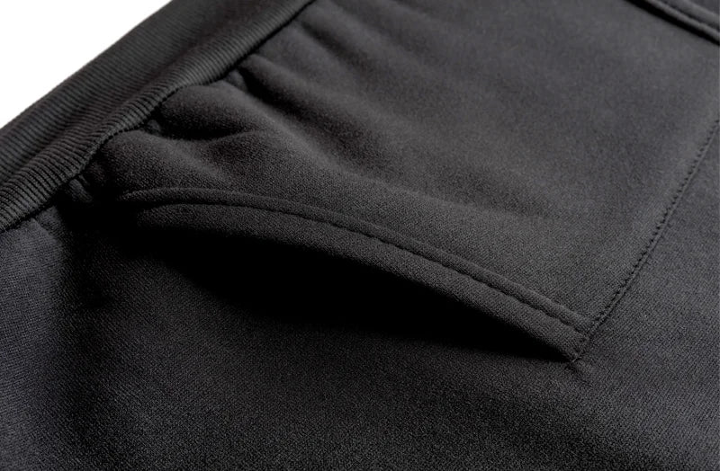 Close-up of black fabric with a focus on texture and stitching detail.