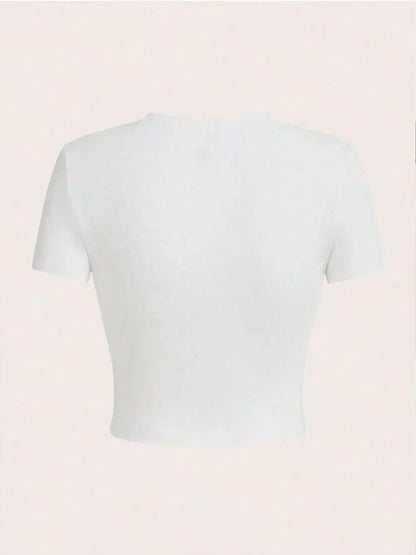 White crop top on a light pink background