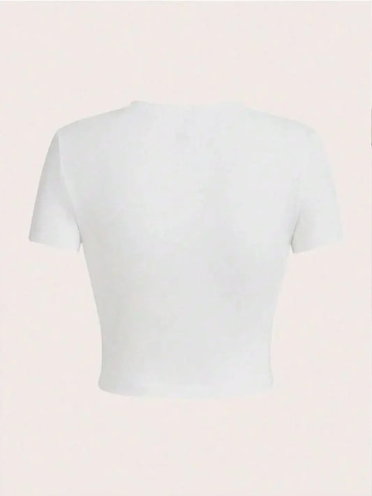 White crop top on a light pink background