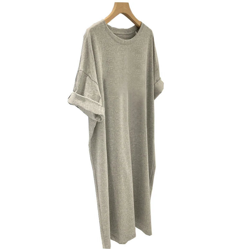 Gray dress on a wooden hanger against a white background