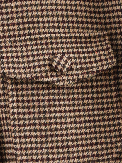 Close-up of a houndstooth patterned fabric with a pocket detail.