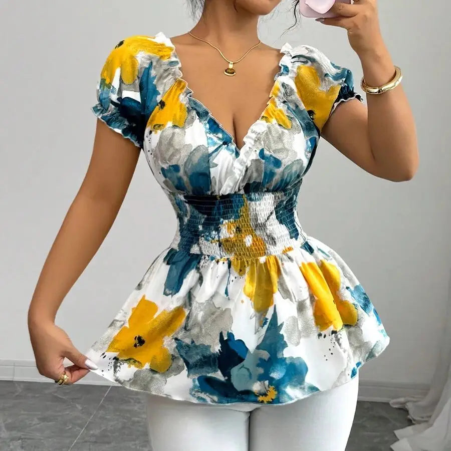 Woman wearing a floral dress with yellow and blue flowers on a plain background