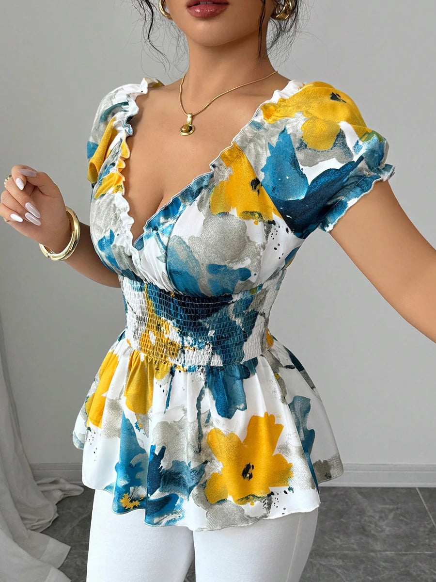 Woman wearing a colorful floral dress with puffed sleeves against a neutral background
