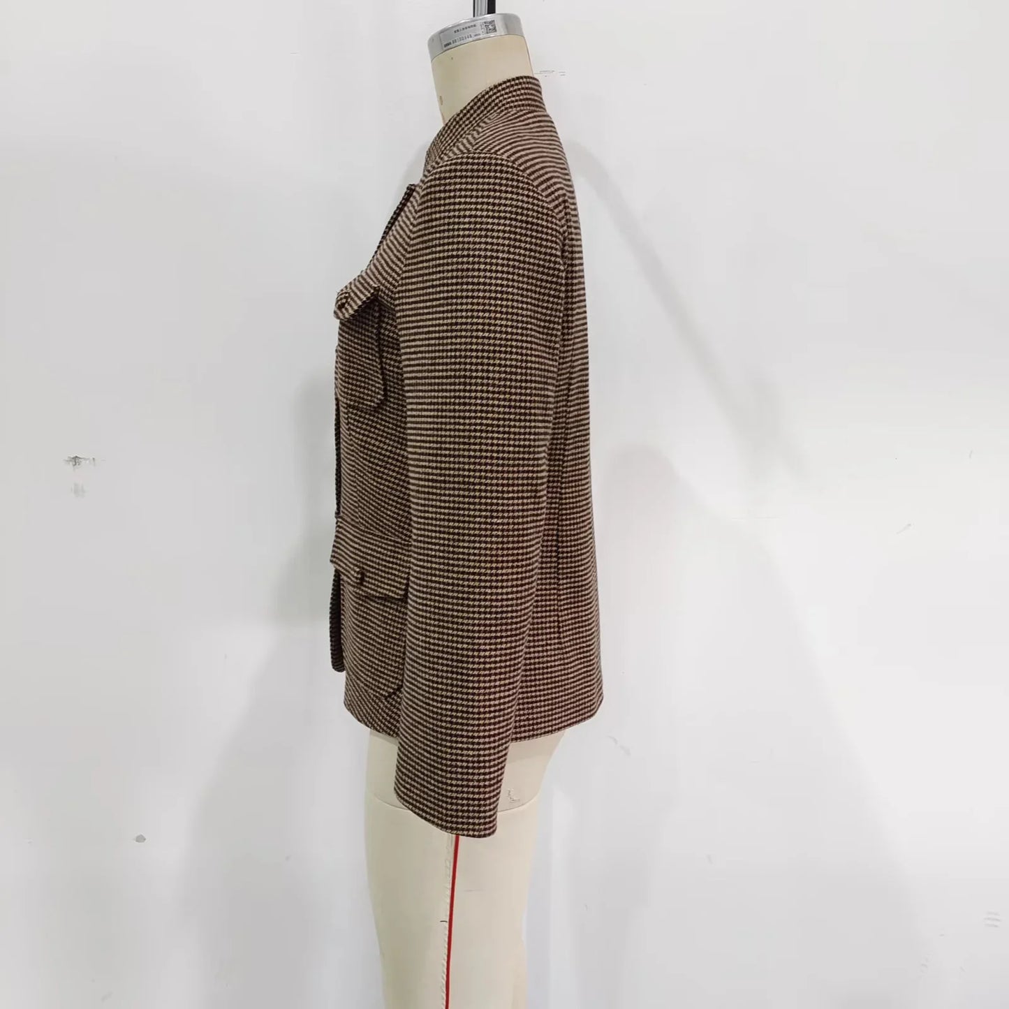 Brown checkered blazer on a mannequin against a white background
