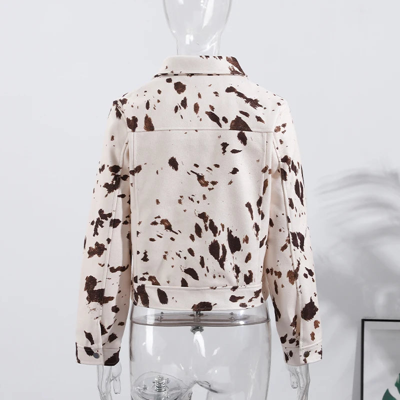 White jacket with brown speckles on a mannequin against a light gray background