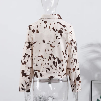 White jacket with brown speckles on a mannequin against a light gray background
