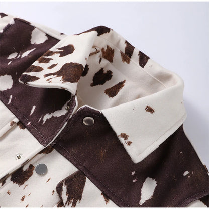 Close-up of a brown and white patterned fabric with a collar on a light gray background