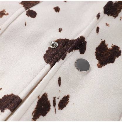 Close-up of a coat with brown abstract pattern and silver buttons on a white background