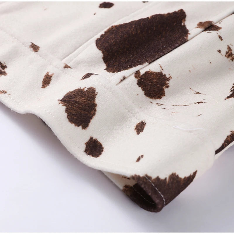 Close-up of a cow print pattern on a white background