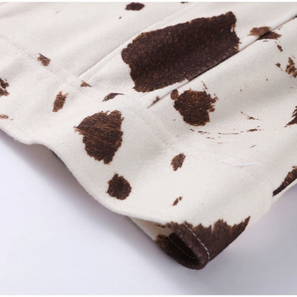 Close-up of a cow print pattern on a white background