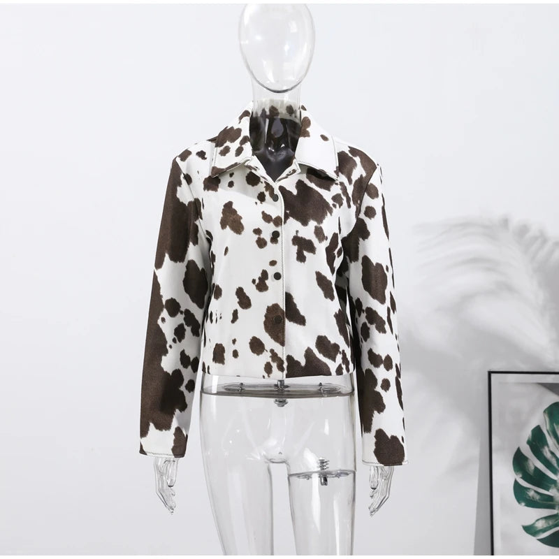 Cow print jacket on a mannequin against a white background