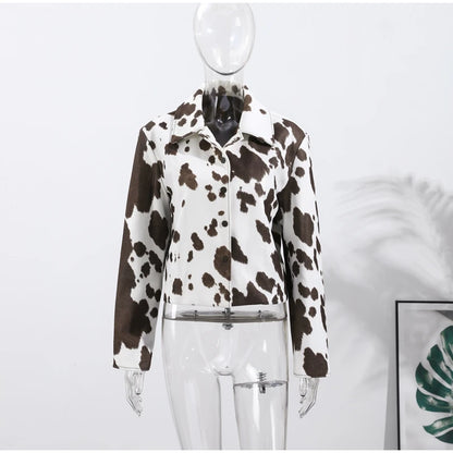 Cow print jacket on a mannequin against a white background