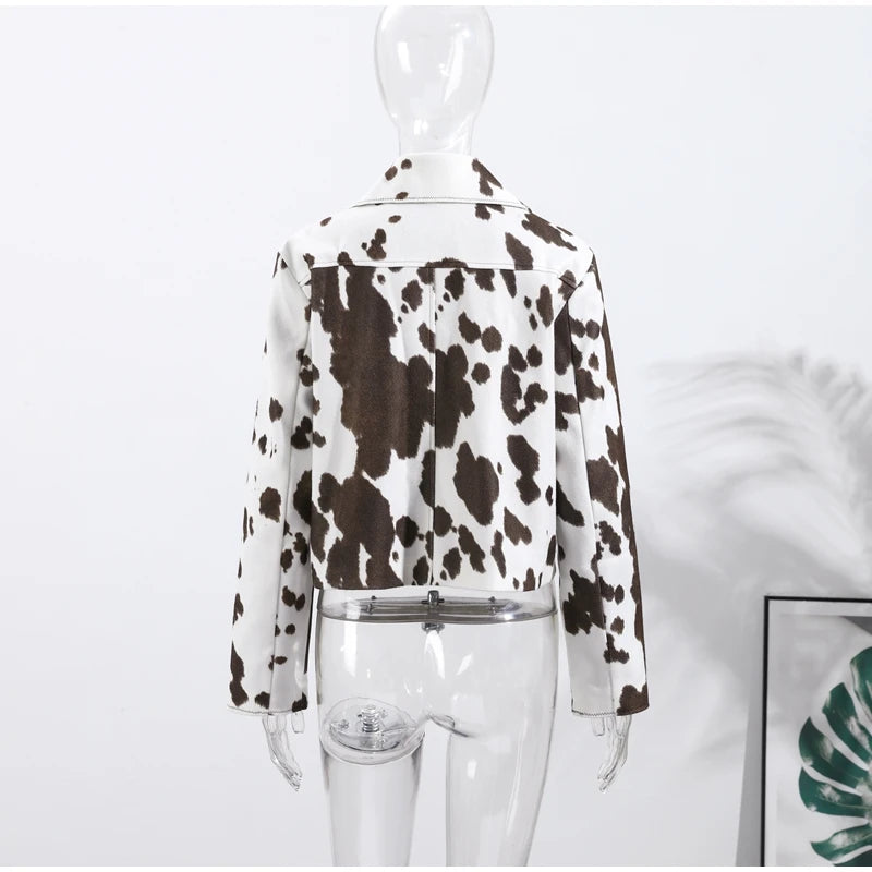 Mannequin wearing a cow print jacket on a white background