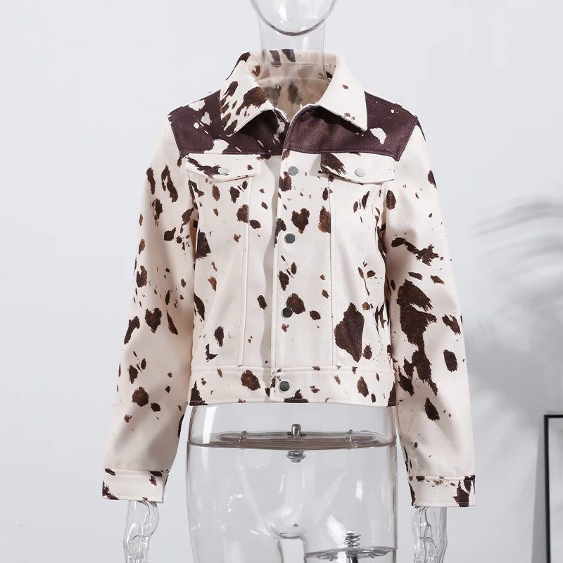 Cow print jacket on a mannequin against a white background
