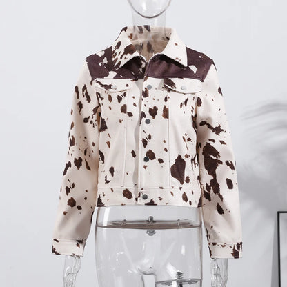 Cow print jacket on a mannequin against a white background
