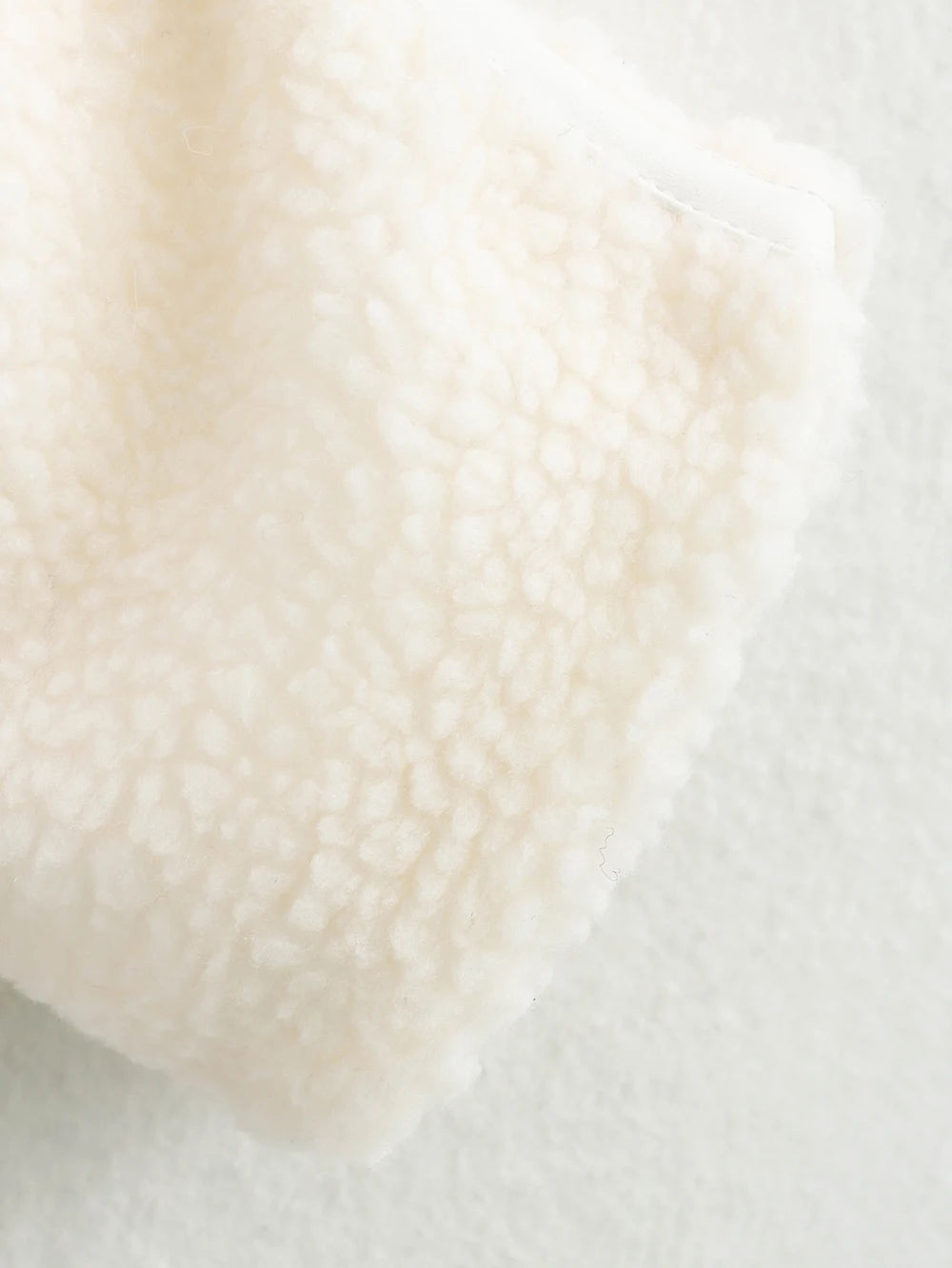 Close-up of a textured beige fabric on a light background