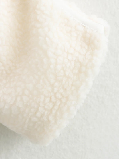 Close-up of a textured beige fabric on a light background