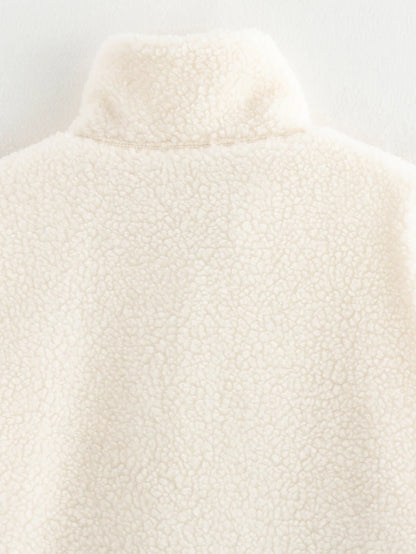 Close-up of a textured white garment on a light gray background