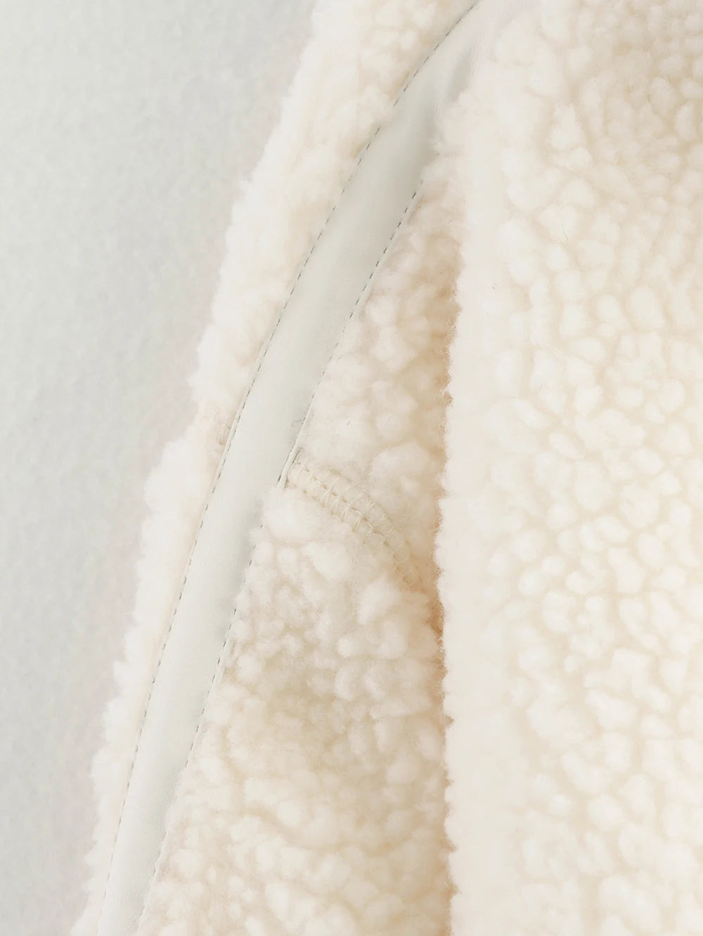 Close-up of a textured white fabric with a neutral background