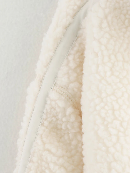 Close-up of a textured white fabric with a neutral background