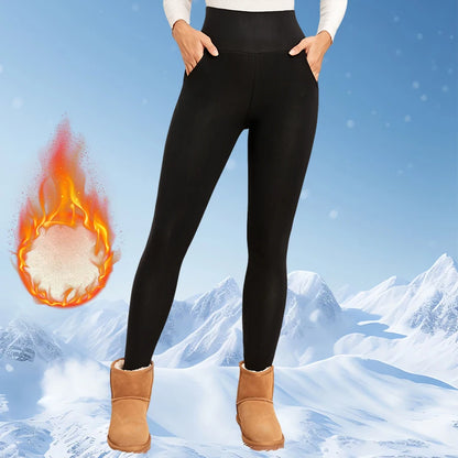 Person wearing black leggings with a snowy mountain background and a flame graphic.