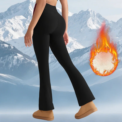 Person wearing black leggings with a fiery ball graphic against a snowy mountain background