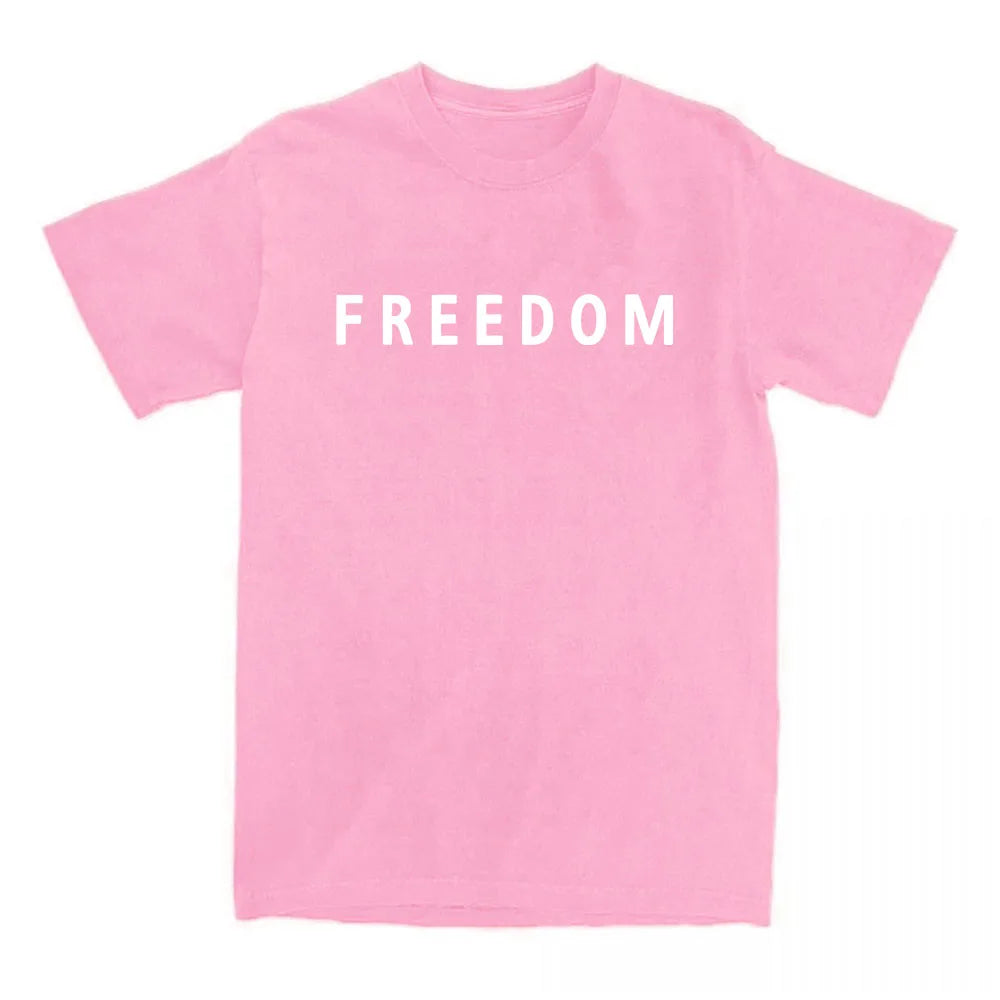 Pink t-shirt with 'FREEDOM' printed on it against a white background