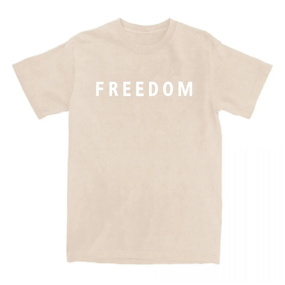 Beige t-shirt with 'FREEDOM' printed on a white background