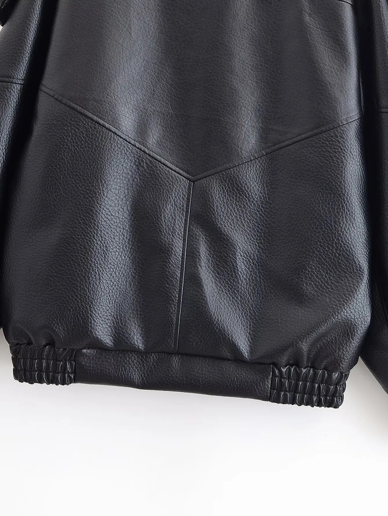 Close-up of a black leather jacket on a white background