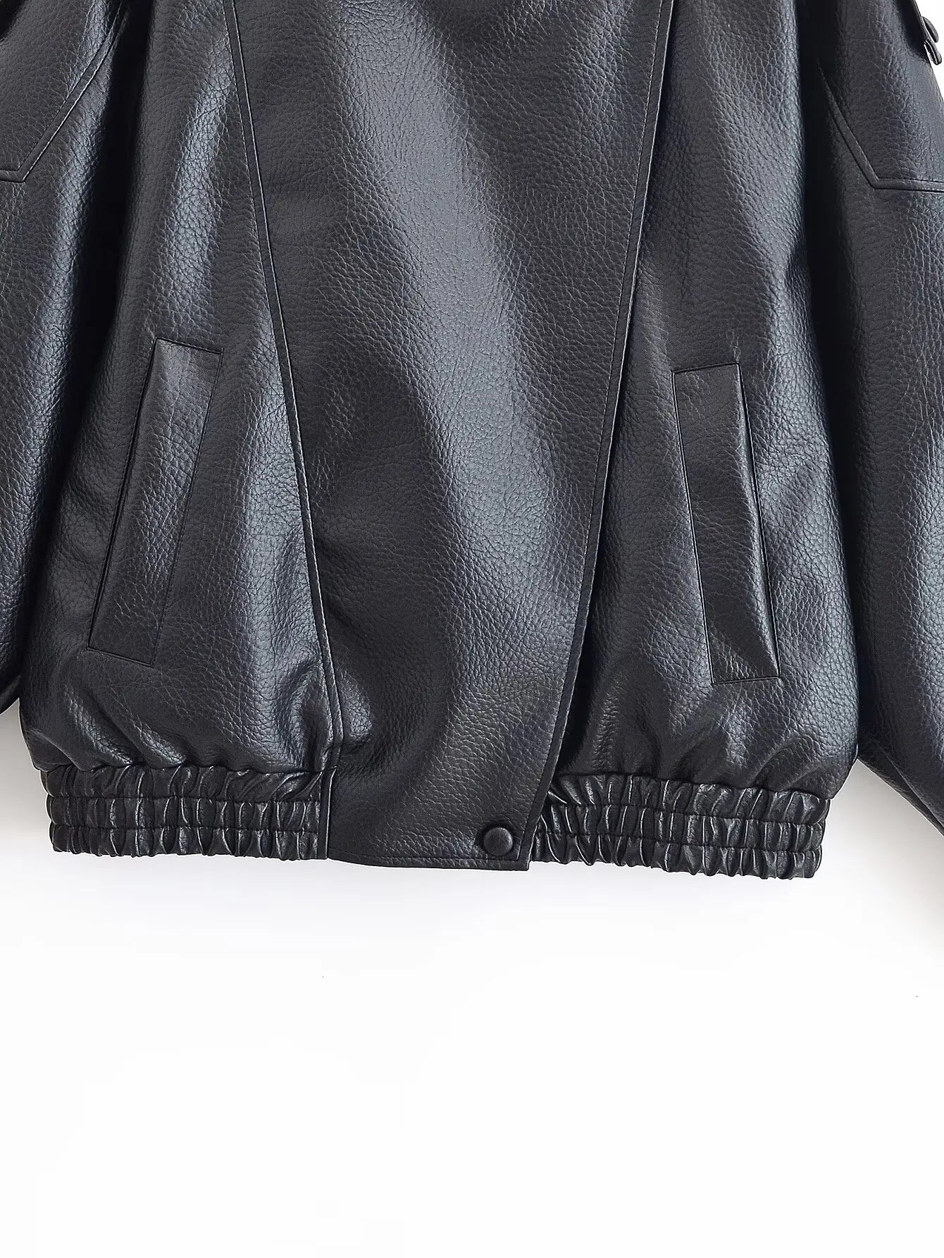 Close-up of a black leather jacket on a white background