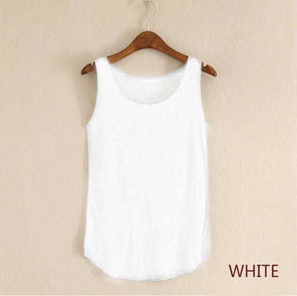 White tank top on a wooden hanger against a beige background