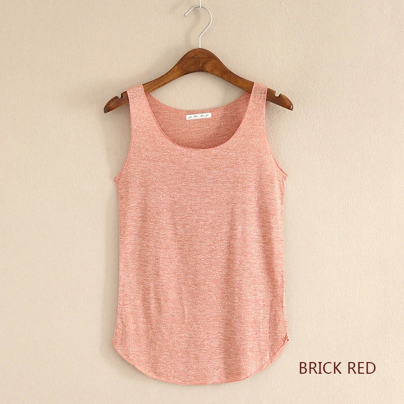 Brick red tank top on a wooden hanger against a beige background