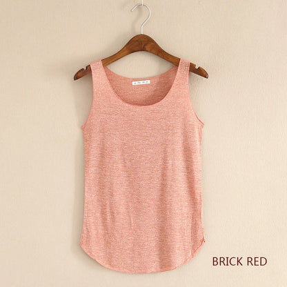 Brick red tank top on a wooden hanger against a beige background