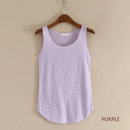 Purple tank top on a wooden hanger against a beige wall