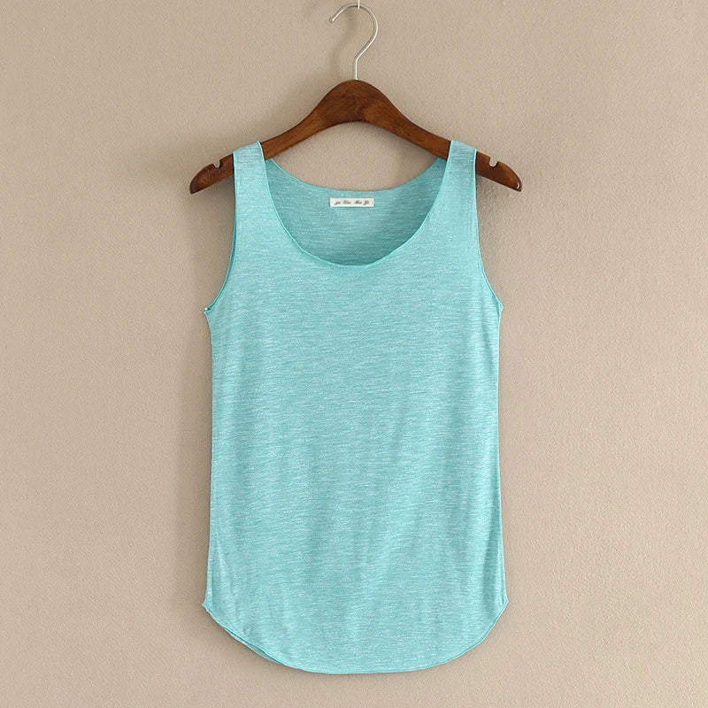 Turquoise tank top on a wooden hanger against a beige wall