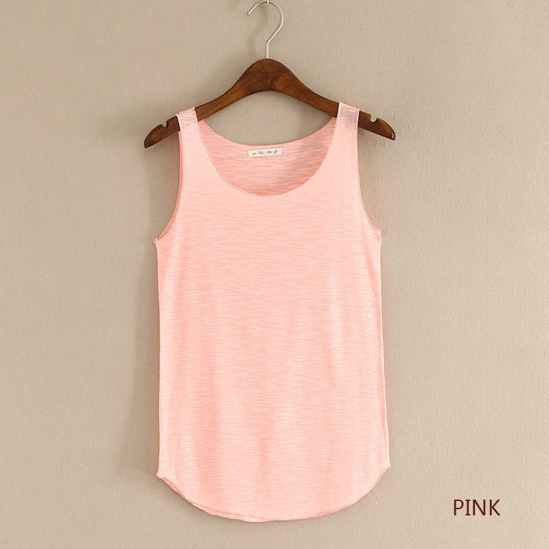 Pink tank top on a wooden hanger against a beige wall with 'PINK' text.