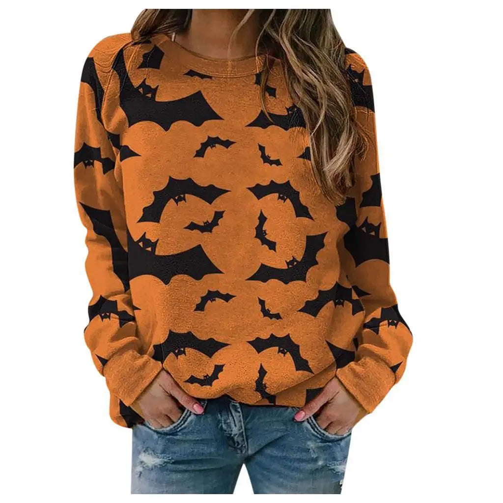 Orange sweatshirt with black bat patterns worn by a person on a white background