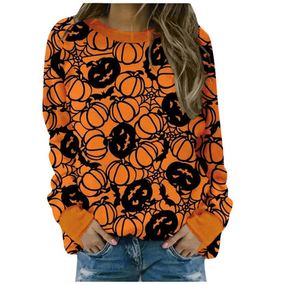 Orange sweatshirt with black pumpkin and spider web pattern worn by a person.