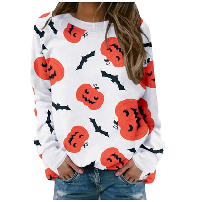 White sweatshirt with Halloween-themed pumpkin and bat pattern worn by a person.